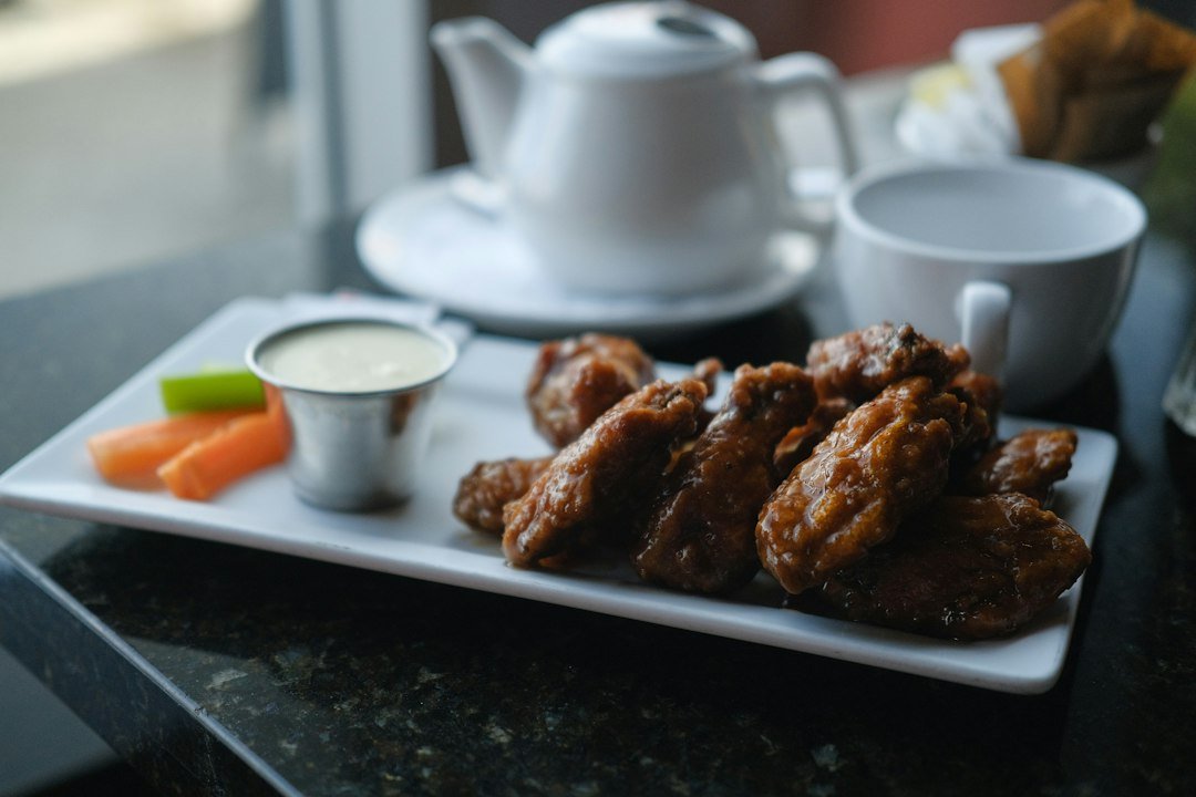 Crispy chicken wings served with dipping sauce and vegetables