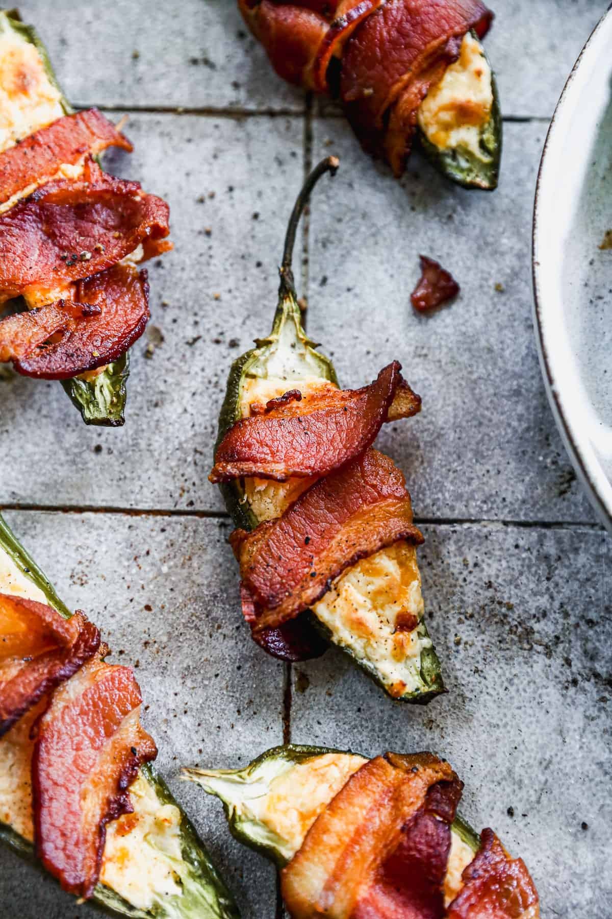 Bacon wrapped jalapeño poppers filled with cream cheese and cheddar
