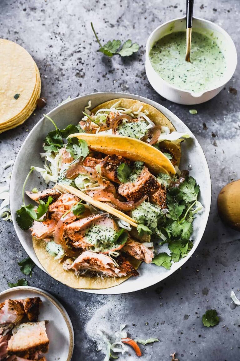 Blackened salmon tacos with cabbage, onion, and cilantro lime sauce