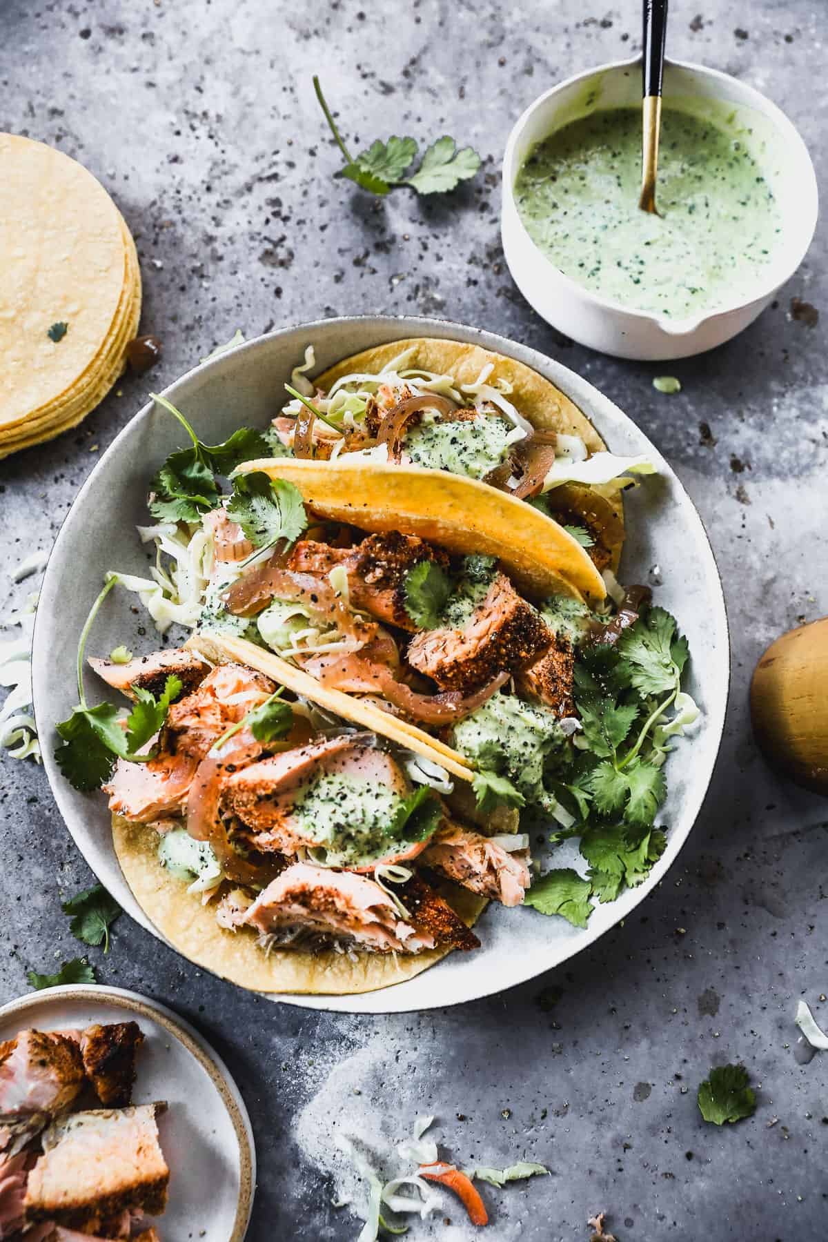 Blackened salmon tacos with cabbage, onion, and cilantro lime sauce