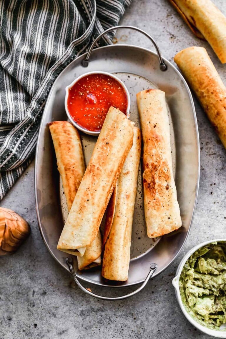 Crispy bean and cheese burritos on a plate with salsa