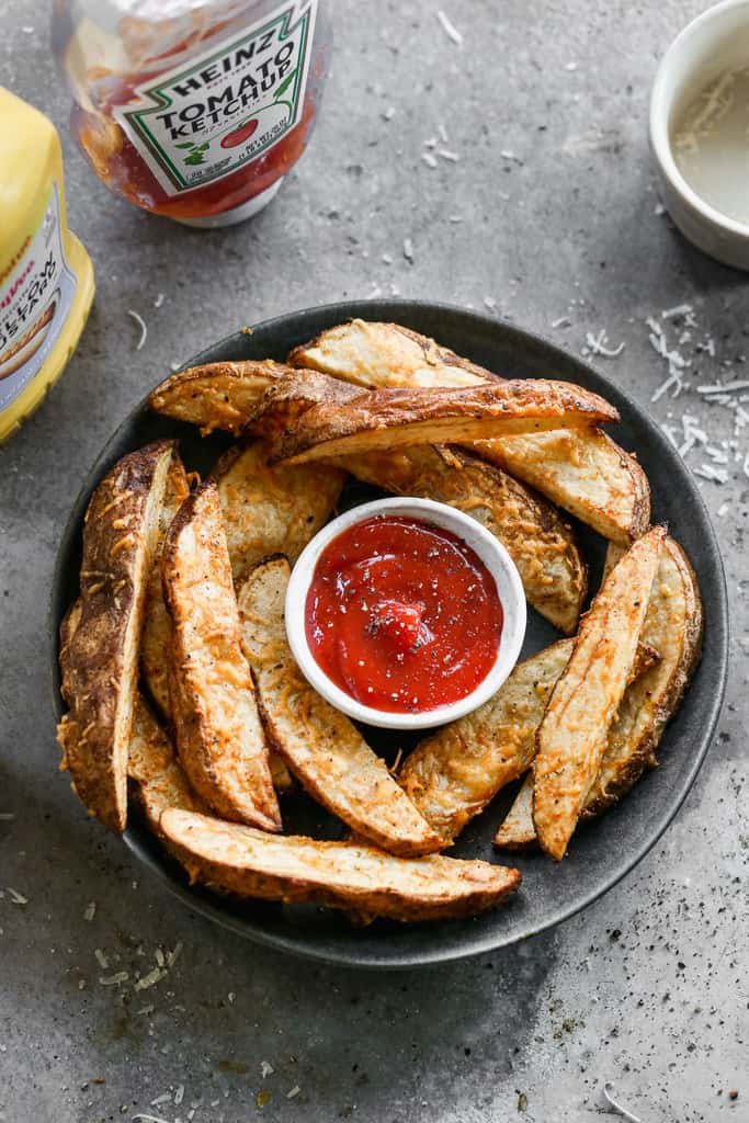 Air fryer potato wedges with parmesan cheese on a plate